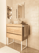 Nahaufnahme: Möbelkufen GRAZ in Weiß, 35 cm hoch, montiert unter einem Sideboard mit Holzfront